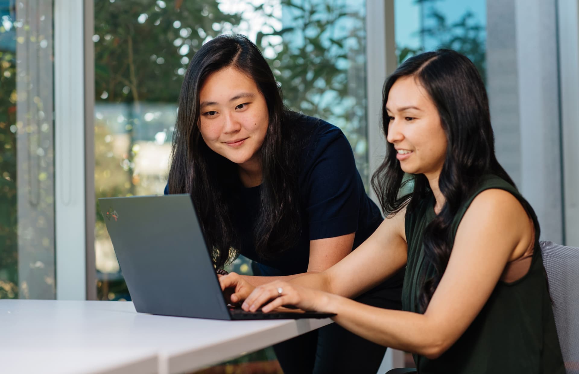 Two women looking at a laptop together